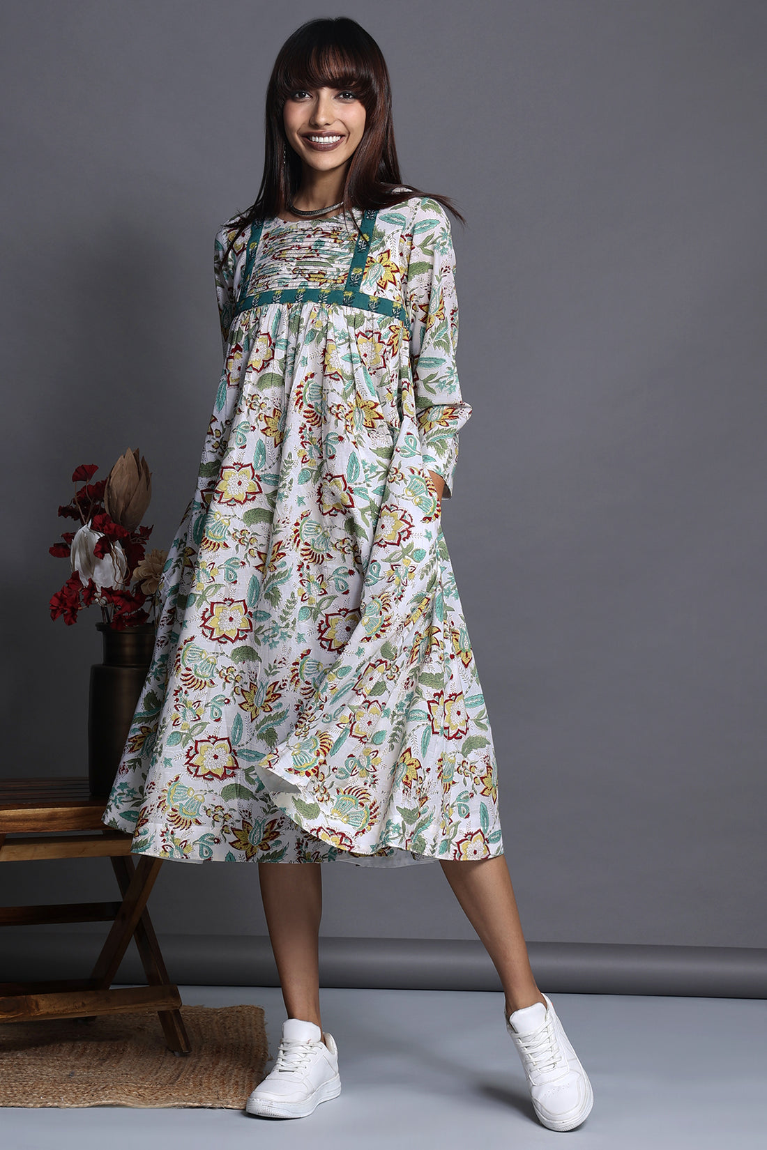 Vintage swirl flare dress in white delicate floral print with high bust yoke and gathers with green printed trims 